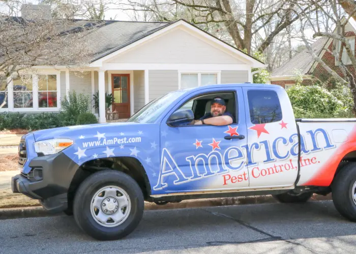 An American Pest Control, Inc. technician in a service truck after implementing boxelder bug control for an Athens, GA home.