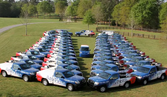 A fleet of American Pest Control, Inc. service trucks in Hartwell, GA