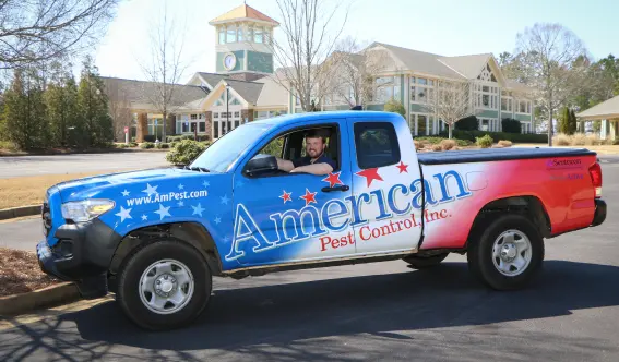 An American Pest Control, Inc. technician sitting in truck after pest application. Contact or call Monday through Friday for your pest control needs.