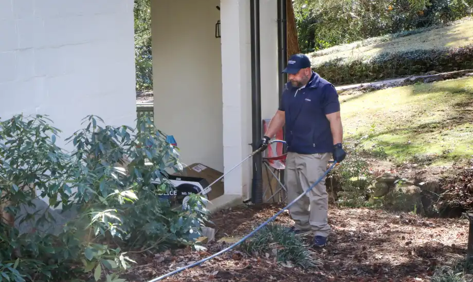 An American Pest Control, Inc. technician applies liquid Termidorยฎ to create a termite barrier around an Athens, GA home
