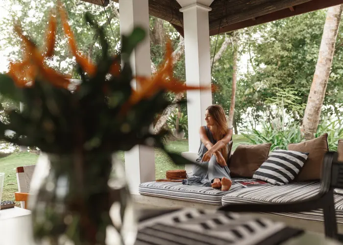 A young homeowner in Athens, GA enjoying her backyard veranda after mosquito treatment by American Pest Control, Inc.