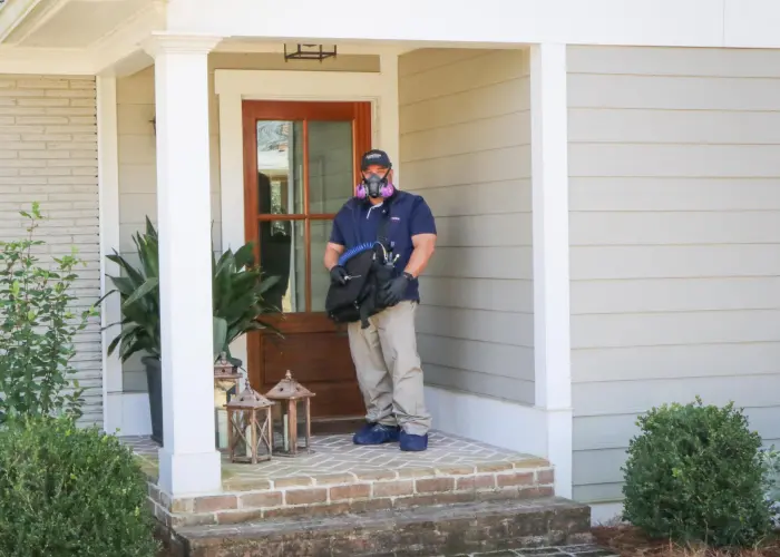 An American Pest Control, Inc. technician prepares for moth treatment inside an Athens, GA home
