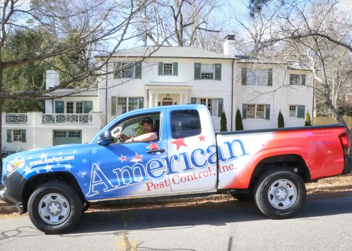 An American Pest Control, Inc. technician in a service truck after applying fly control treatment to an Athens, GA home