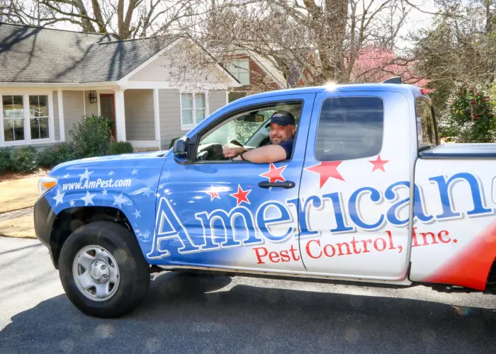 An American Pest Control, Inc. technician in a service truck after completing squirrel removal services in Athens, GA