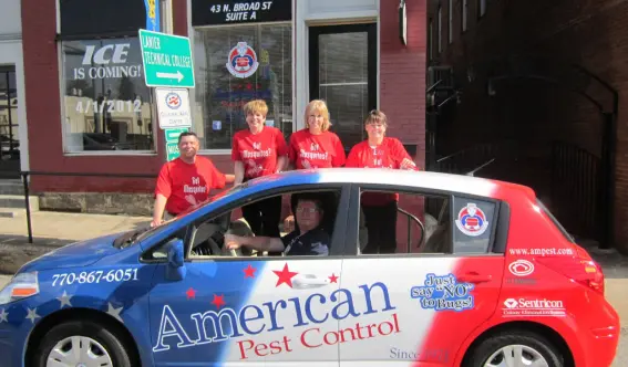 American Pest Control, Inc. team standing with service vehicle in Winder, GA